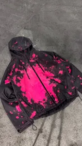 Detailed view of black waterproof jacket with temperature-sensitive pink color change