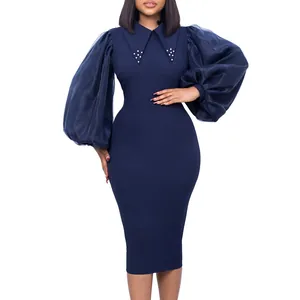 Detail view of navy pencil dress featuring sheer mesh puff sleeves and beaded collar.