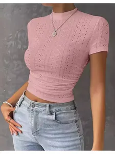 Slim fit pink short sleeve eyelet knitted crop top featuring ruched sides and a mock neck design