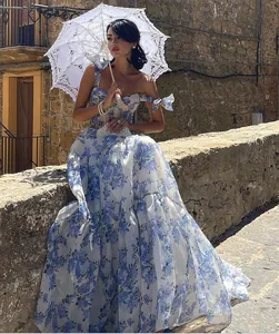 Elegant off-shoulder blue floral organza maxi evening dress for summer occasions.