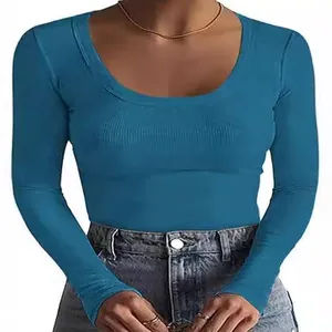 Detailed view of the ribbed fabric and scoop neck design on this long sleeve blue top.