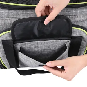 Detailed macro view showing the functional Velcro storage pocket of a gray pet carrier bag