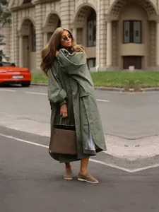Elegant oversized olive green long trench coat with lantern sleeves and stand collar.