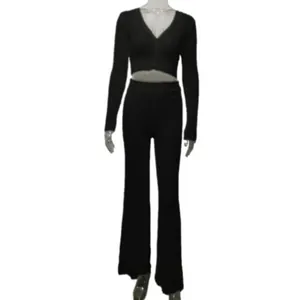 Full view of women's ribbed black knit two-piece set with crop top and flared pants.