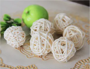 Close-up view of six natural beige rattan bird foot toys for parrots on decorative mat.