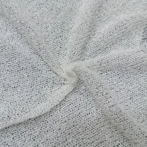 Detailed close-up of white knitted hollow fabric showing breathable texture and patterns