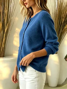 Detailed side view of a soft blue button-up knit cardigan sweater with gold buttons.