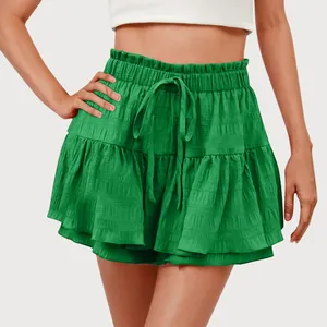 Detailed view of green ruffled skort with elastic waist and drawstring for women.