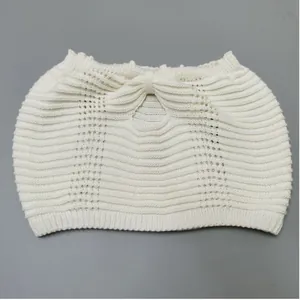 Detailed view of white knitted tube top with elegant bow design and ribbed texture