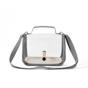 Detail view of transparent bird travel carrier bag with wooden perch and strap