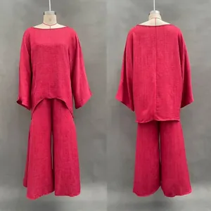 Detail of wine red minimalist loose shirt and wide-leg pants set on professional mannequin