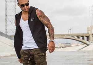 Close-up of sleeveless sports hoodie on muscular model in outdoor setting