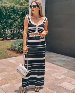 Outdoor shot of a woman in a black and white striped knit crop top and maxi skirt set