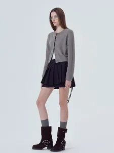 Detailed view of women's grey knit cardigan with long sleeves and button closure