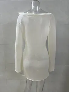 Back view of a white minimalist knitted sheer cover-up dress for sexy beach holiday