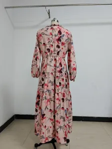 Back view of elegant long sleeve floral maxi dress on mannequin for evening wear