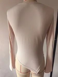 Macro detail showing back of cream slim fit asymmetrical long sleeve top on mannequin