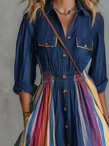 Detail view of retro navy blue shirt dress with colorful vertical striped skirt