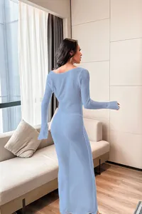 Elegant back view of a blue sheer long sleeve beach cover-up maxi dress in lifestyle setting