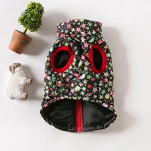 Close-up of a festive Christmas dog vest featuring star patterns and a red zipper detail