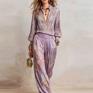 Detailed view of paisley print deep V-neck shirt and wide leg trousers set.
