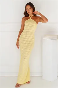 Detailed view of a yellow knitted halter maxi dress with diamond crochet patterns.