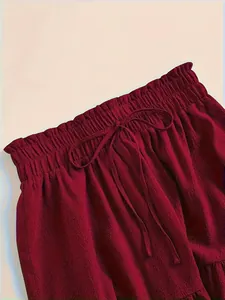 Close-up detail of burgundy tiered skirt with elastic paperbag waist and drawstring