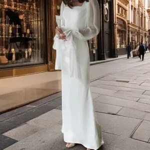 Full-length detail of a white mermaid wedding gown featuring long sleeves and U-neck