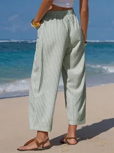 Back view of green striped faux linen wide-leg cropped beach trousers for women