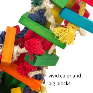 Close-up detail of large colorful wooden blocks and cotton rope on a parrot chew toy