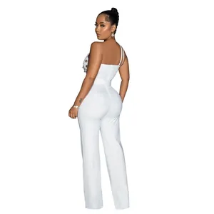 Back view of white one-shoulder jumpsuit with gold button detail and wide leg fit