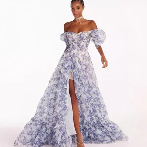 An elegant off-the-shoulder floral organza maxi dress with a high slit and ruffles.