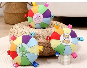 Detailed view of colorful squeaky plush dog frisbees featuring cute animal patterns