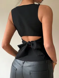 Detail view of a black sleeveless slim-fit top featuring a large back bowknot tie.