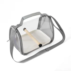 Detail view of portable bird carrier bag with wooden perch and tray inside