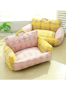 Detailed view of the soft bouclé fabric and cute eye design on a plaid pet sofa bed.