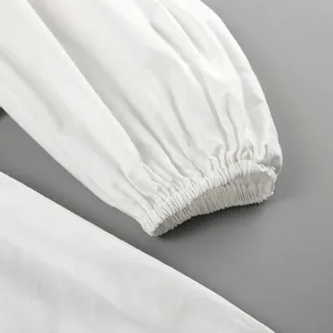 Close-up detail of the elastic cuff on a white cotton linen puff sleeve top for women