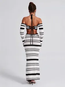 Stylish black and white striped crochet halter top and maxi skirt set with arm sleeves.
