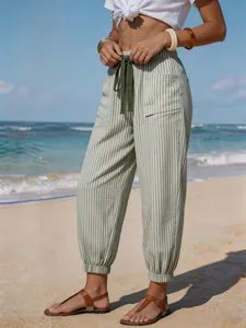 Full view of green striped beach joggers showing elastic cuffs and drawstring waist.