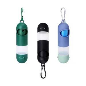 Portable capsule-shaped pet waste bag dispenser with carabiner for outdoor travel.