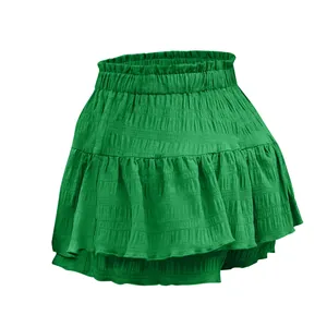 Detail view of a stylish green ruffled skort featuring smocked high waist and layers.