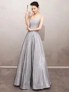 Elegant silver sparkly deep V-neck floor-length evening gown with camisole straps