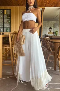 Elegant white wide-leg trousers featuring fringe hem detail for a stylish vacation look
