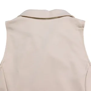 Close-up detail of the lapel collar and back stitching of a beige sleeveless jumpsuit