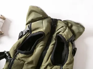 Close-up detail of an olive green dog winter vest showing zipper and harness clips