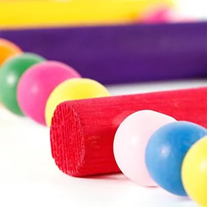 Macro view of vibrant colorful wooden beads and rungs for parrot bird climbing ladder