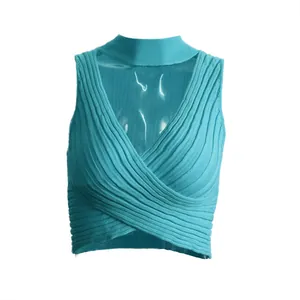 Close-up detail of a turquoise ribbed knit halter crop top with front crossover design