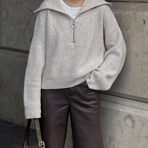 Detail view of retro oversized ribbed knit sweater with zip collar in beige color