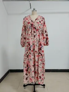 A high-quality front view of an elegant floral print tiered maxi dress on a dress form.