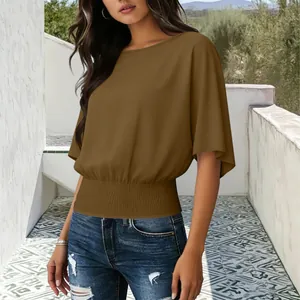 Women's brown short sleeve top featuring a smocked elastic waist and relaxed batwing fit